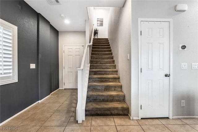 stairway featuring tile patterned floors