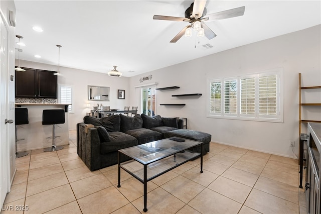 living room with light tile patterned flooring and ceiling fan