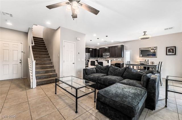 tiled living room featuring ceiling fan