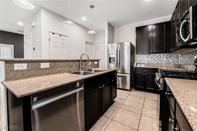 kitchen featuring pendant lighting, sink, appliances with stainless steel finishes, light stone countertops, and light tile patterned flooring