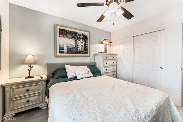 bedroom with hardwood / wood-style floors, ceiling fan, and a closet