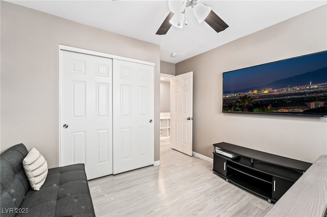 living room featuring light hardwood / wood-style floors and ceiling fan