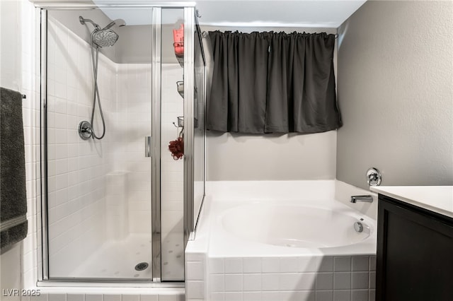 bathroom featuring plus walk in shower and vanity