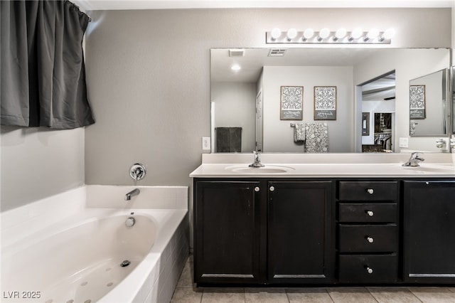 bathroom featuring vanity, tile patterned floors, and a bathtub