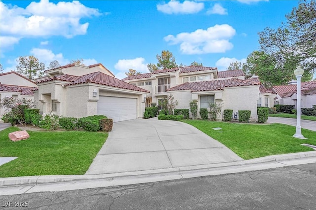 mediterranean / spanish-style house featuring a garage and a front lawn