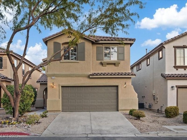 mediterranean / spanish-style home with a garage