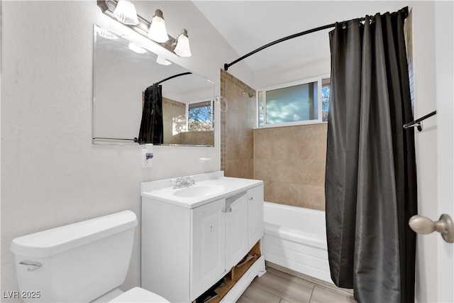 full bathroom with vanity, shower / bath combo, and toilet