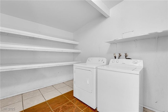 washroom with independent washer and dryer and tile patterned floors