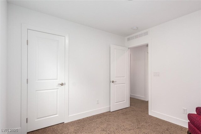 unfurnished bedroom featuring light colored carpet