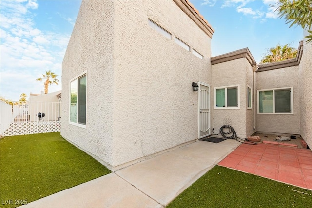 back of property featuring a yard and a patio area