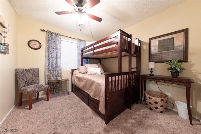 carpeted bedroom with ceiling fan and a textured ceiling