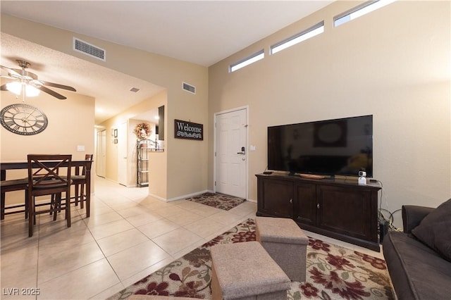 tiled living room featuring ceiling fan