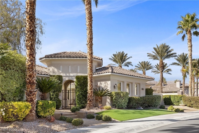 mediterranean / spanish-style home with a front yard