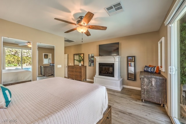 bedroom with light wood-type flooring and ceiling fan