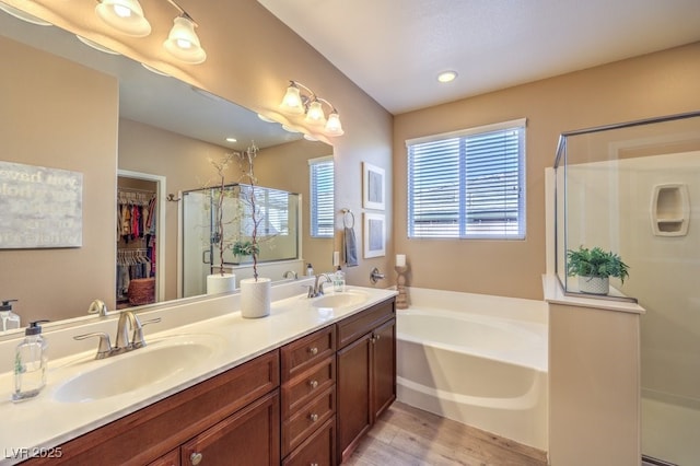 bathroom with vanity, separate shower and tub, and hardwood / wood-style floors