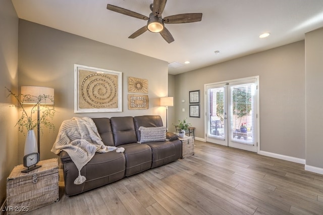 living room with ceiling fan and wood-type flooring