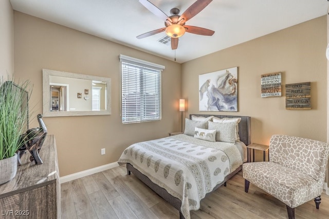 bedroom with ceiling fan and light hardwood / wood-style flooring