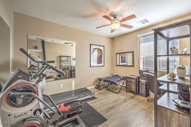 workout room featuring ceiling fan and light hardwood / wood-style floors