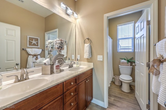 bathroom with vanity, hardwood / wood-style flooring, and toilet