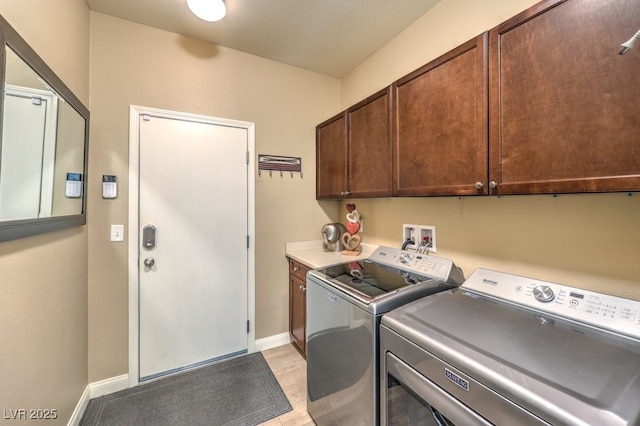 laundry area with cabinets and washer and dryer