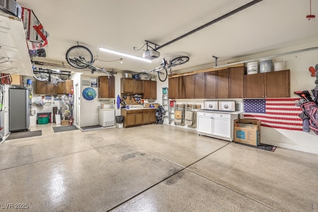 garage featuring a garage door opener and a workshop area