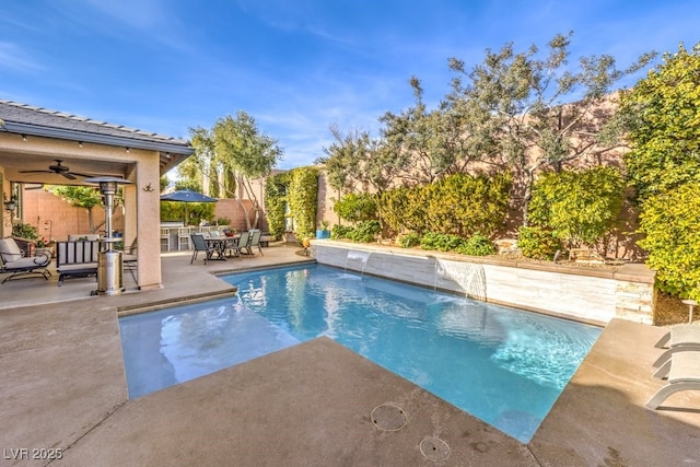 view of swimming pool with a patio, pool water feature, and ceiling fan