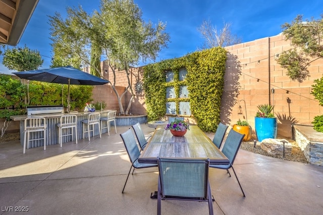 view of patio with a grill and a bar