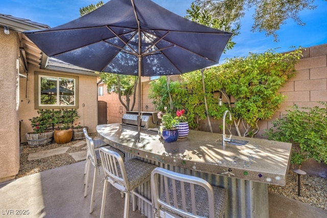 view of patio with a grill and an outdoor bar