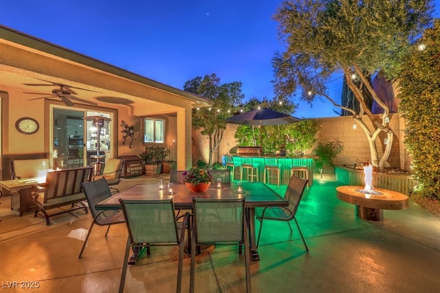 view of patio / terrace featuring ceiling fan and an outdoor fire pit