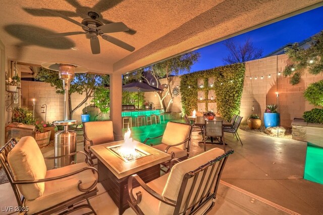 view of patio / terrace featuring ceiling fan and an outdoor fire pit