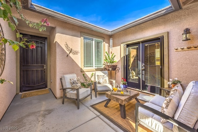 doorway to property with french doors, an outdoor hangout area, and a patio area