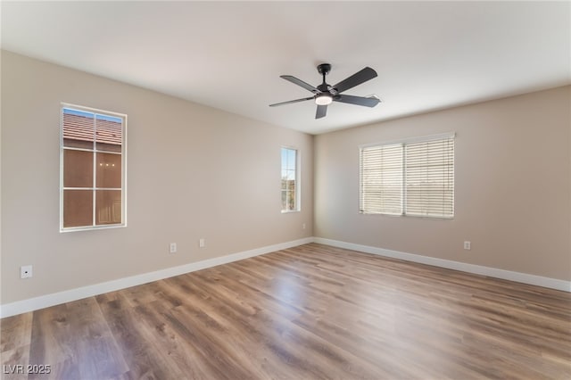 spare room featuring ceiling fan and hardwood / wood-style floors