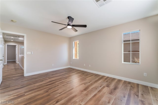 spare room with hardwood / wood-style flooring and ceiling fan