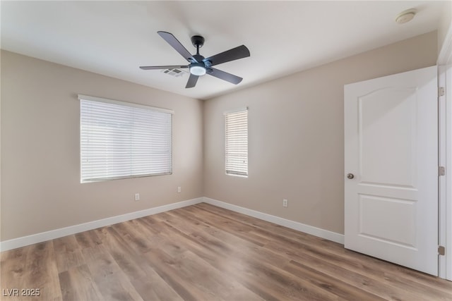 unfurnished room with ceiling fan and light wood-type flooring