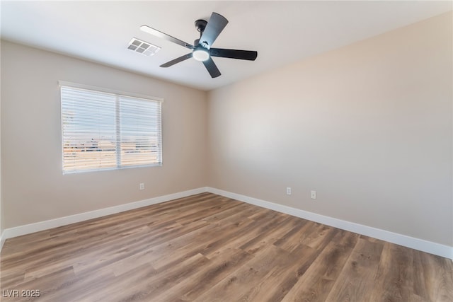 empty room with ceiling fan and hardwood / wood-style floors