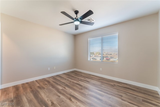 spare room with hardwood / wood-style flooring and ceiling fan