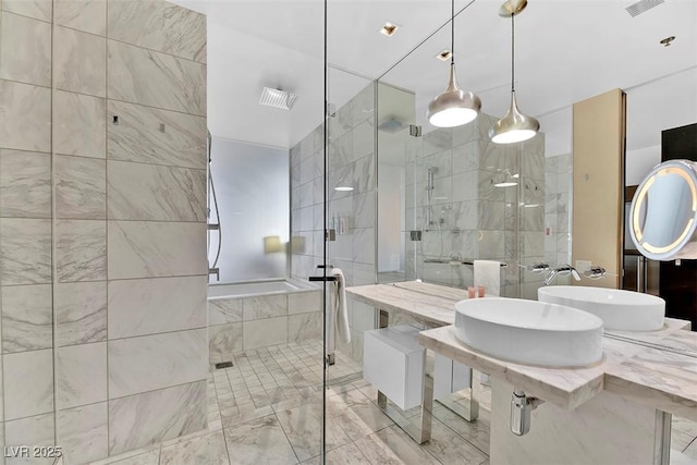 bathroom featuring an enclosed shower and sink