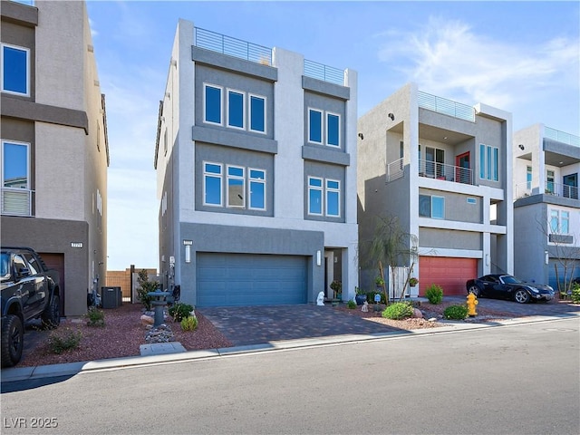 view of front of property with a garage and central air condition unit