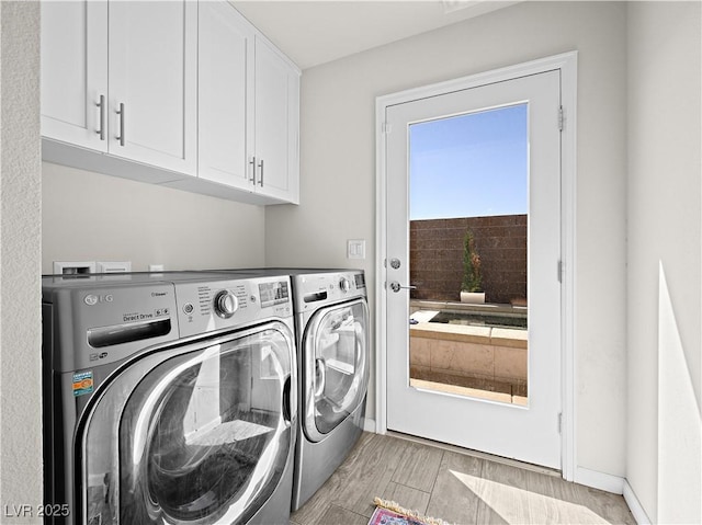 laundry area featuring independent washer and dryer and cabinets