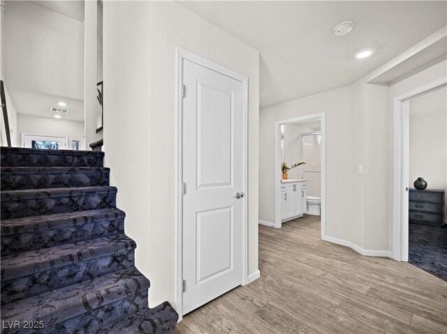 stairway featuring hardwood / wood-style flooring