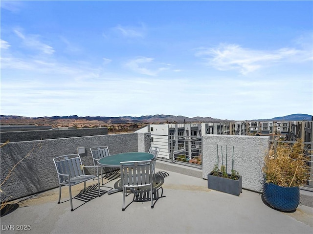 view of patio / terrace with a balcony and a mountain view