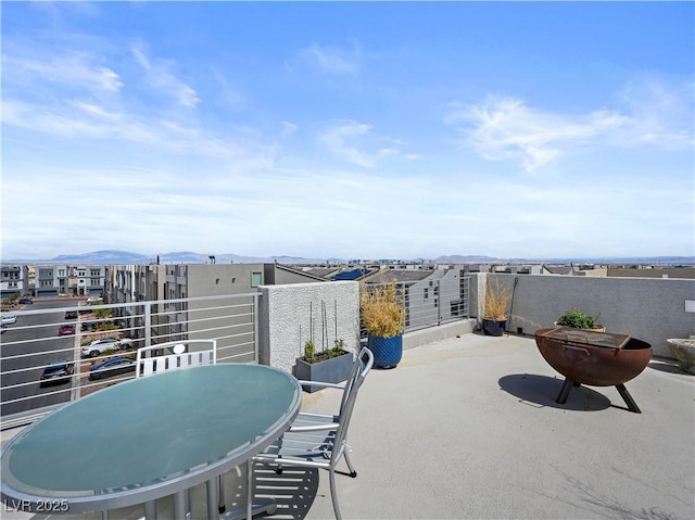 view of patio with a balcony and a mountain view