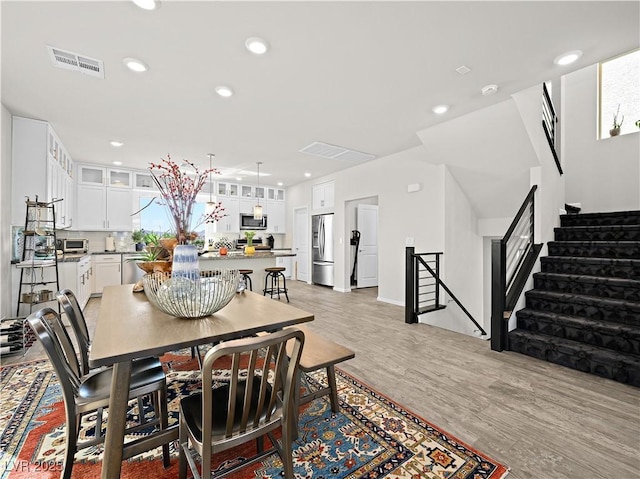 dining room with light hardwood / wood-style flooring