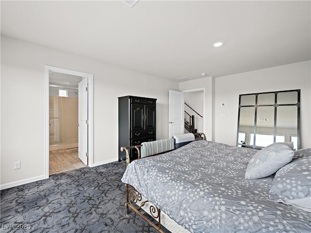 carpeted bedroom with ensuite bathroom