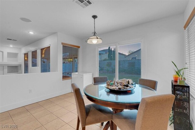 dining room featuring light tile patterned floors, baseboards, and recessed lighting