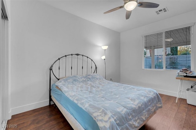 bedroom with dark hardwood / wood-style floors and ceiling fan