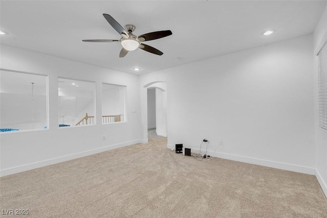 carpeted empty room featuring ceiling fan