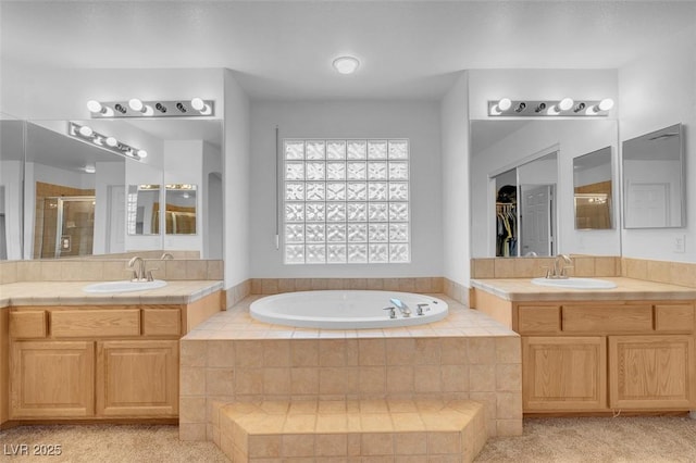 bathroom featuring shower with separate bathtub and vanity