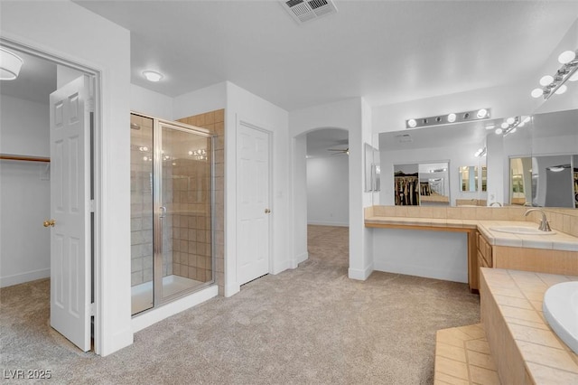 bathroom featuring vanity, shower with separate bathtub, and ceiling fan