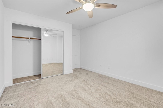 unfurnished bedroom with light carpet, a closet, and ceiling fan